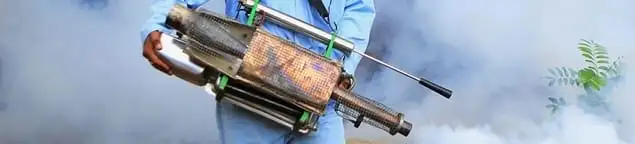 Fumigation technician using a fogger for deep pest treatment in Staten Island, NY